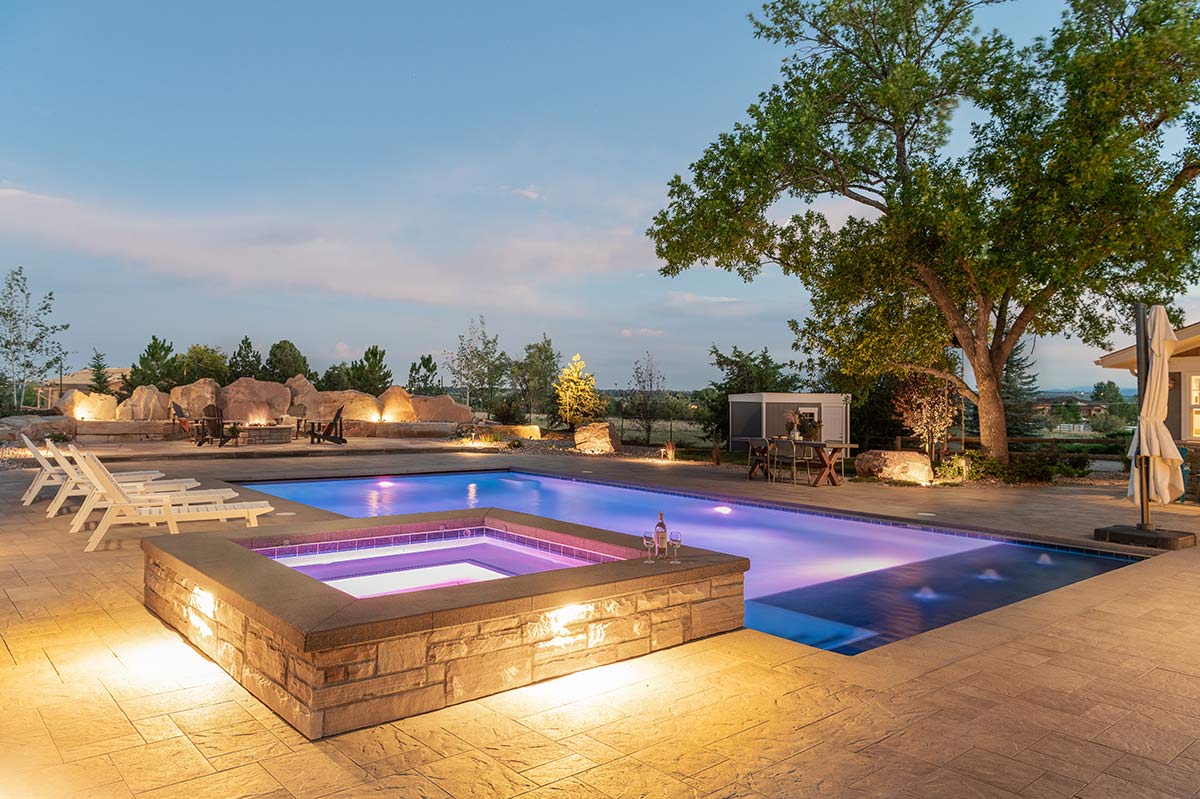 Nighttime image of a pool illuminated by a color-changing LEDs in Longmont Colorado