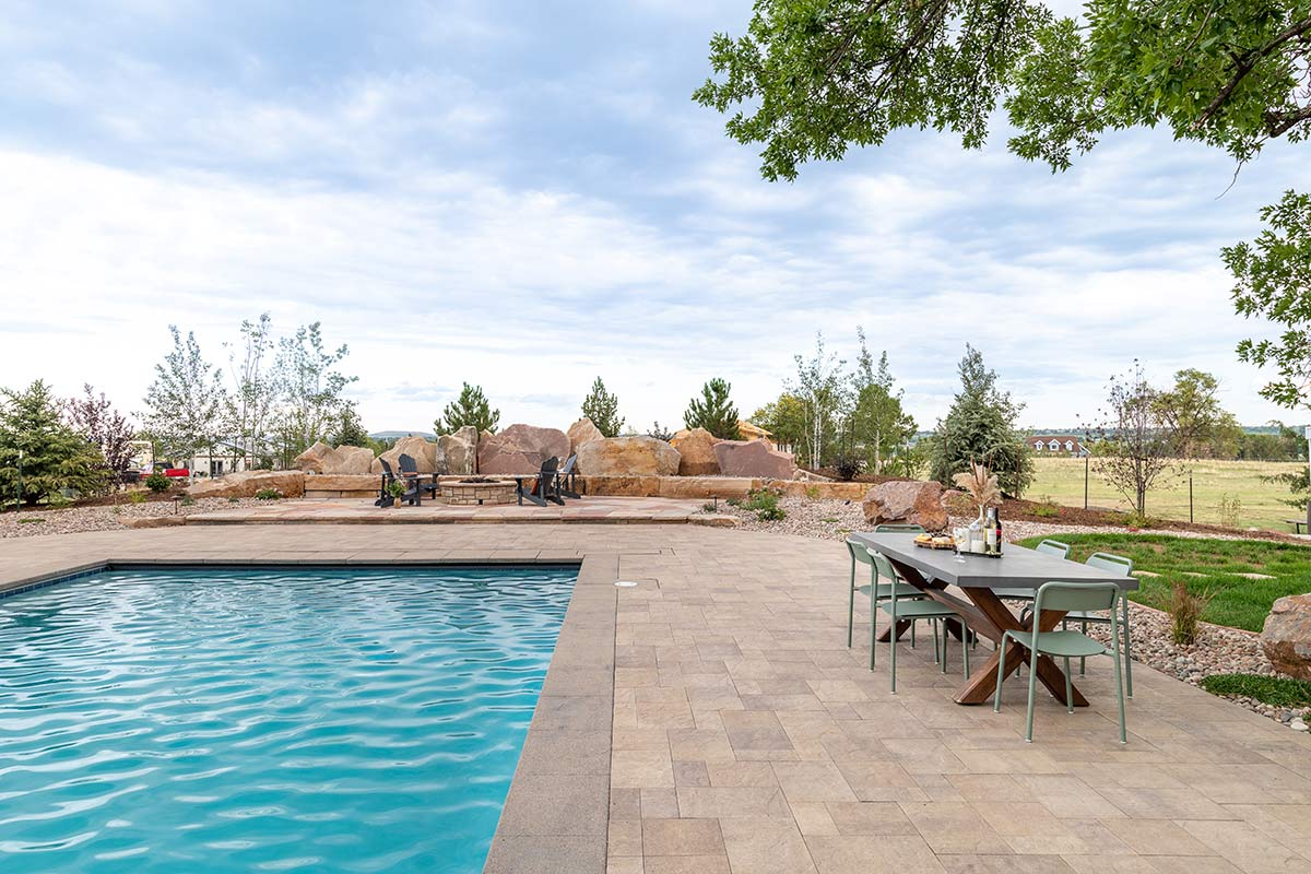 Modern pool with a paver patio created by Kristen Whitehead and Helios Landscape Design.
