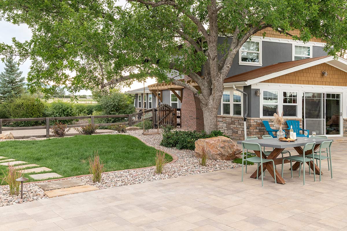 Stone walkway with a custom paved patio and a functional outdoor living space.